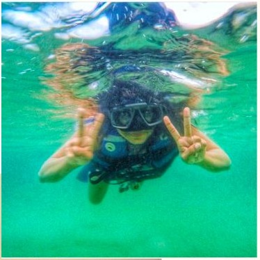 Sanali exploring a marine environment underwater