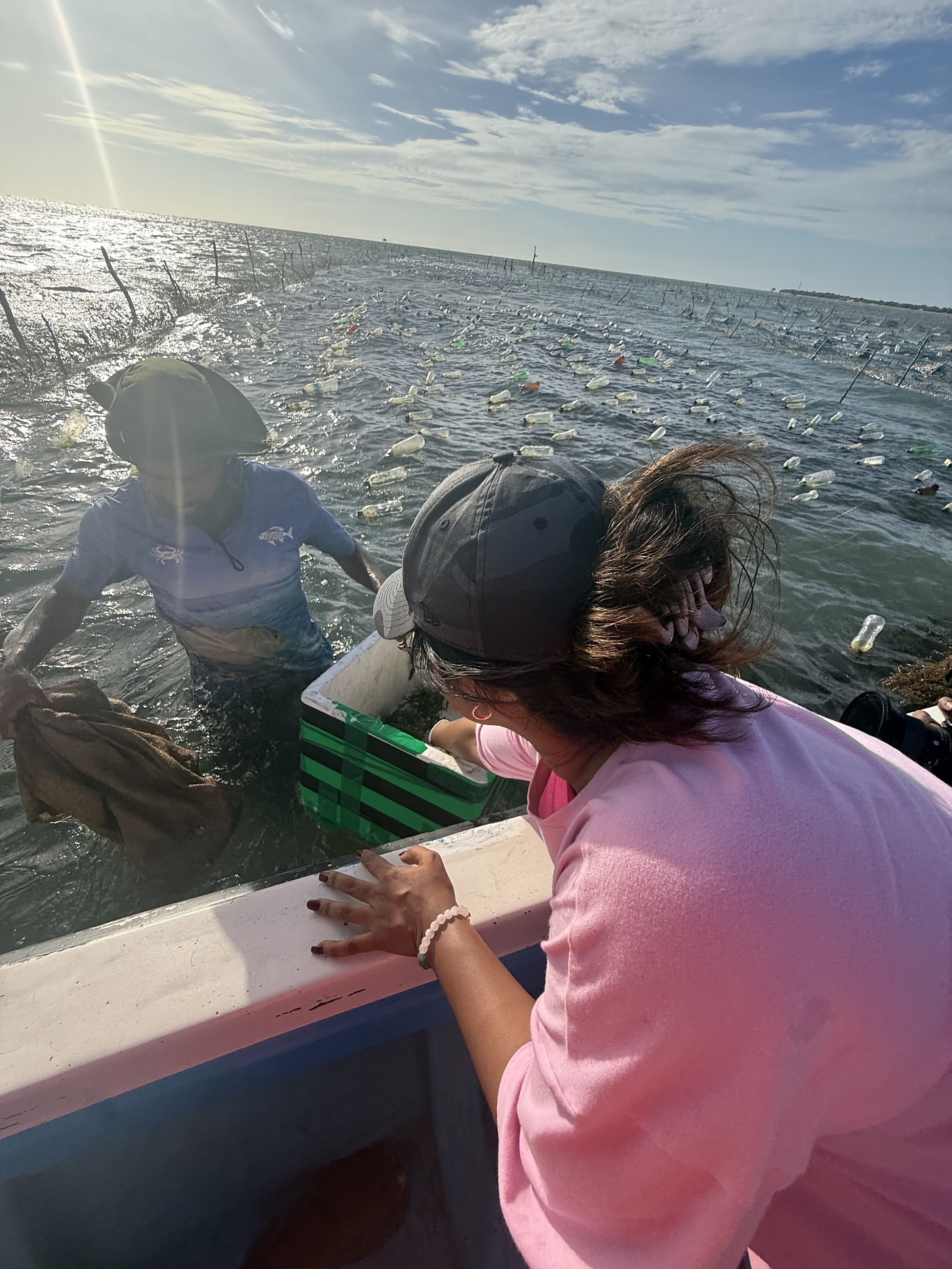 Sanali learning about seaweed handling aboard a small boat